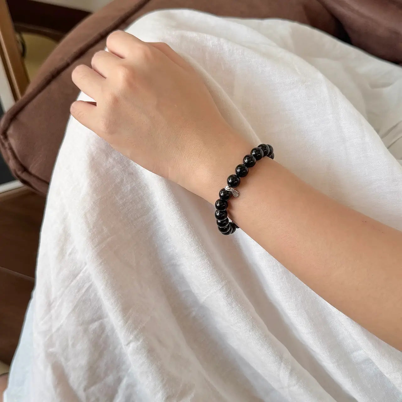 8mm black tourmaline bead bracelet worn on wrist for protection and stability