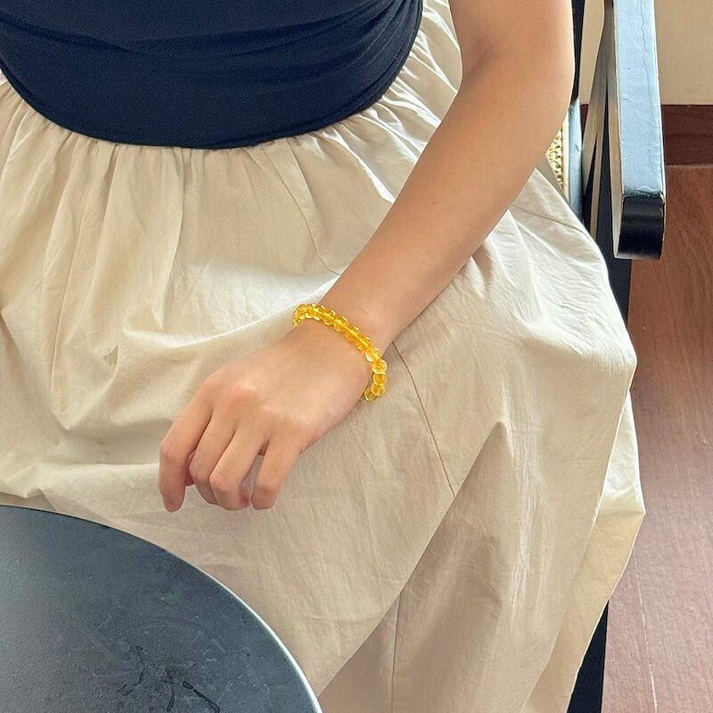 Citrine crystal bracelet worn on wrist with warm yellow sunlight glow