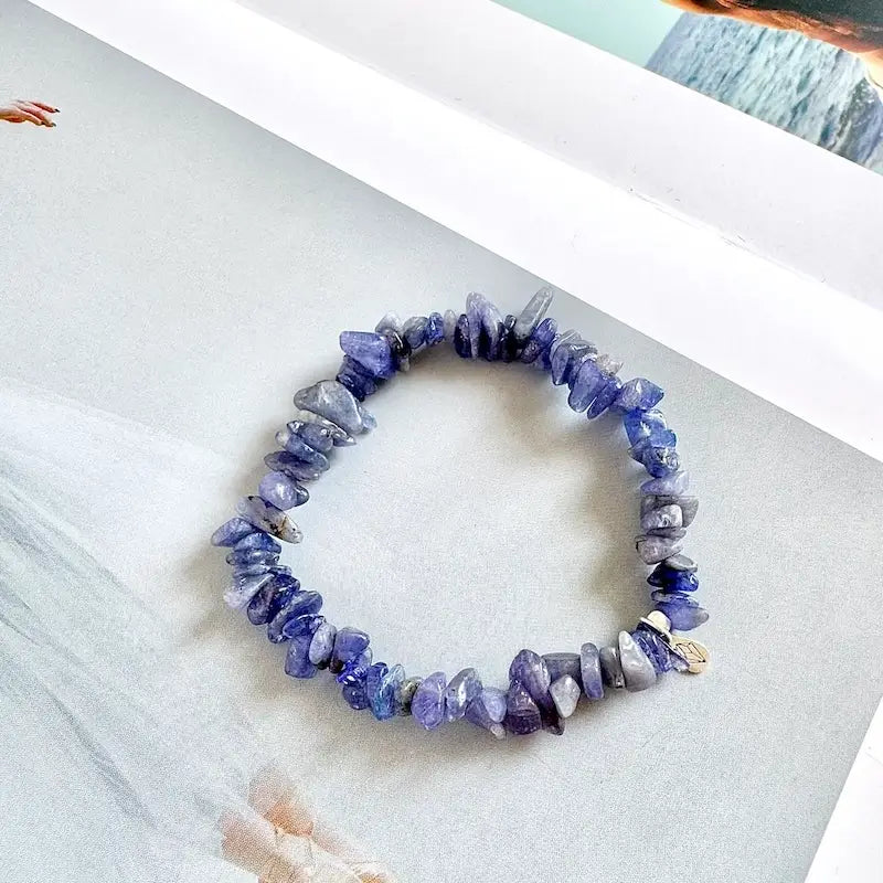 close-up of chip tanzanite stone bracelet showing natural purple blue gemstone texture and surface detail