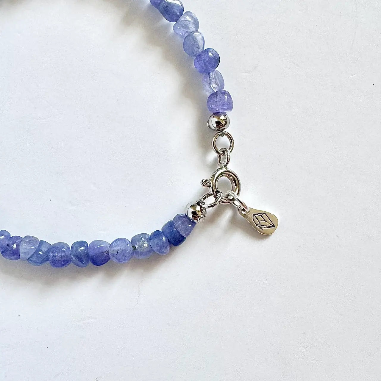 Side view of a tanzanite crystal bracelet showing the natural bead texture
